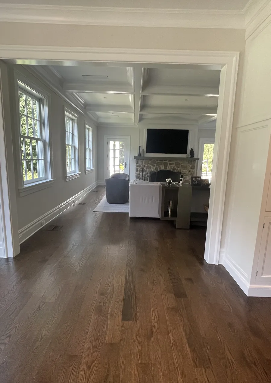 Medium brown stained oak floor in a living room with a coffered ceiling